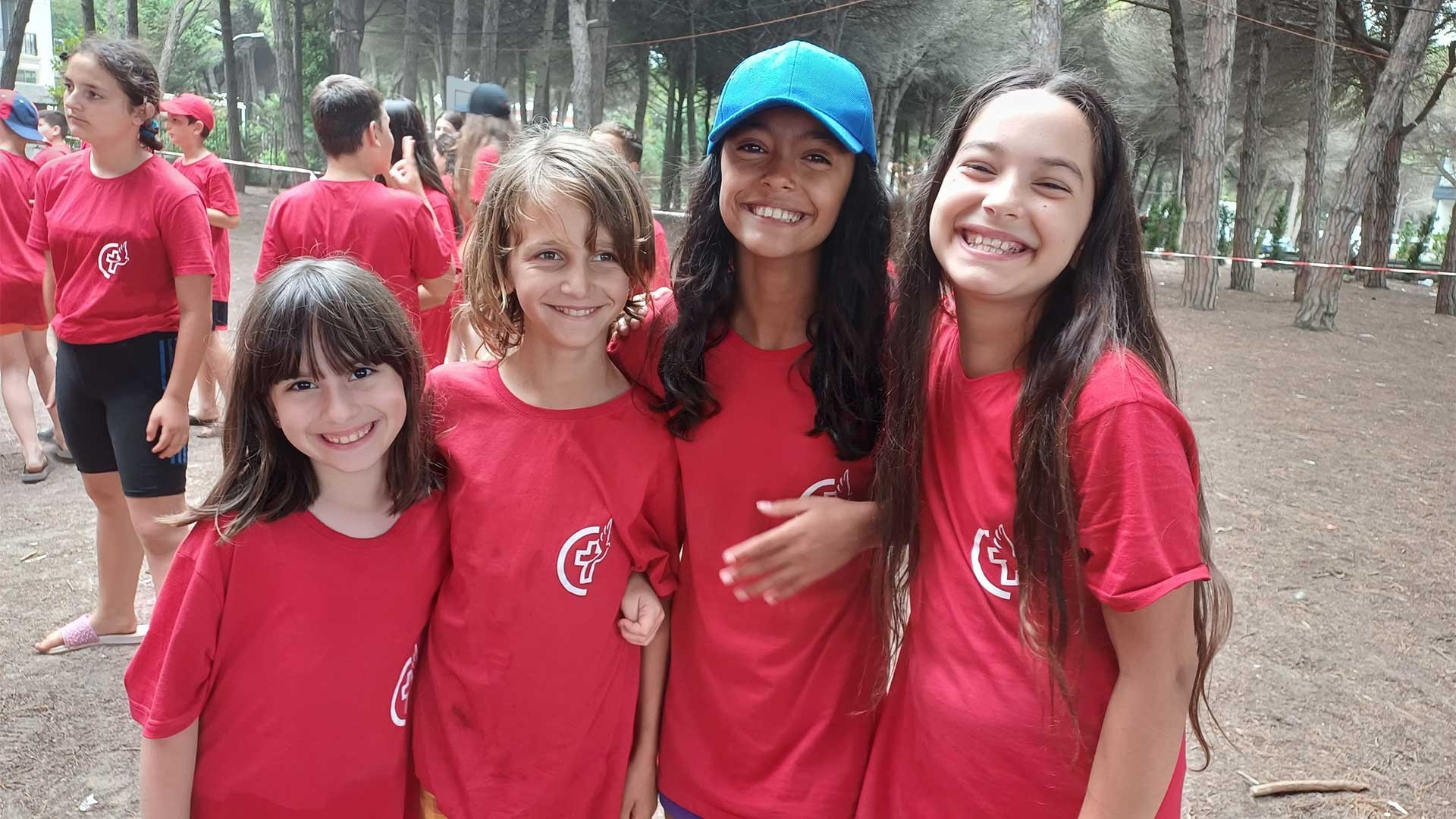 A girl stands with her new friends at Summer Camp.
