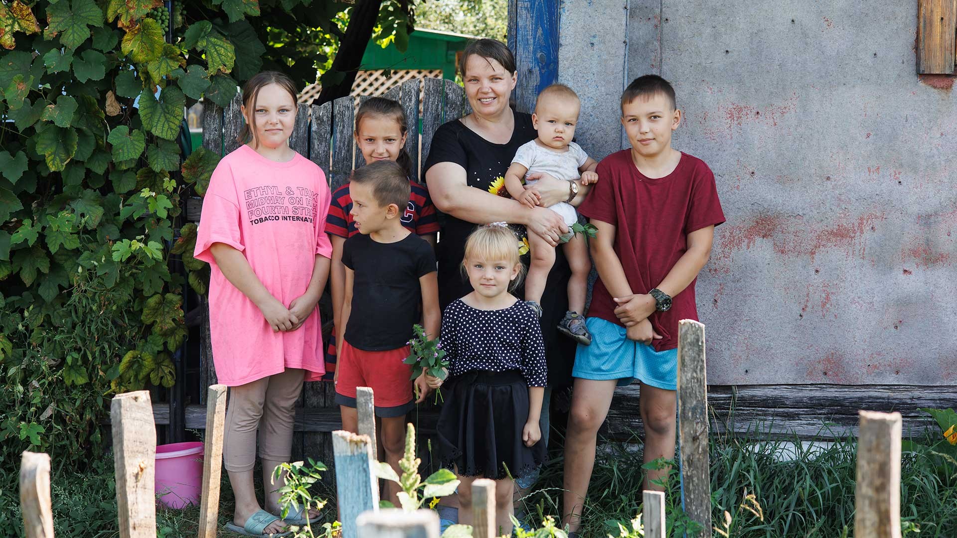 A family stand in their garden.