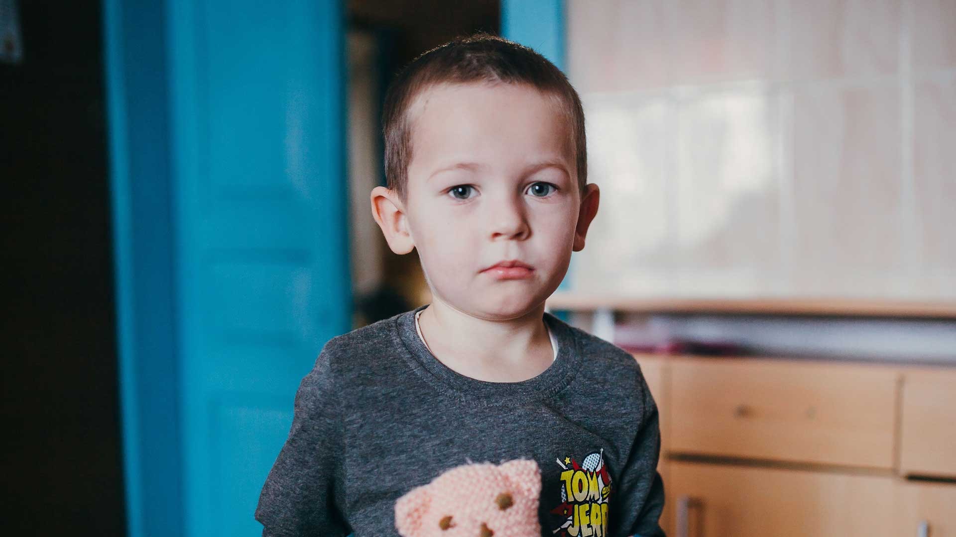 A small boy with a toy bear, Ukraine.