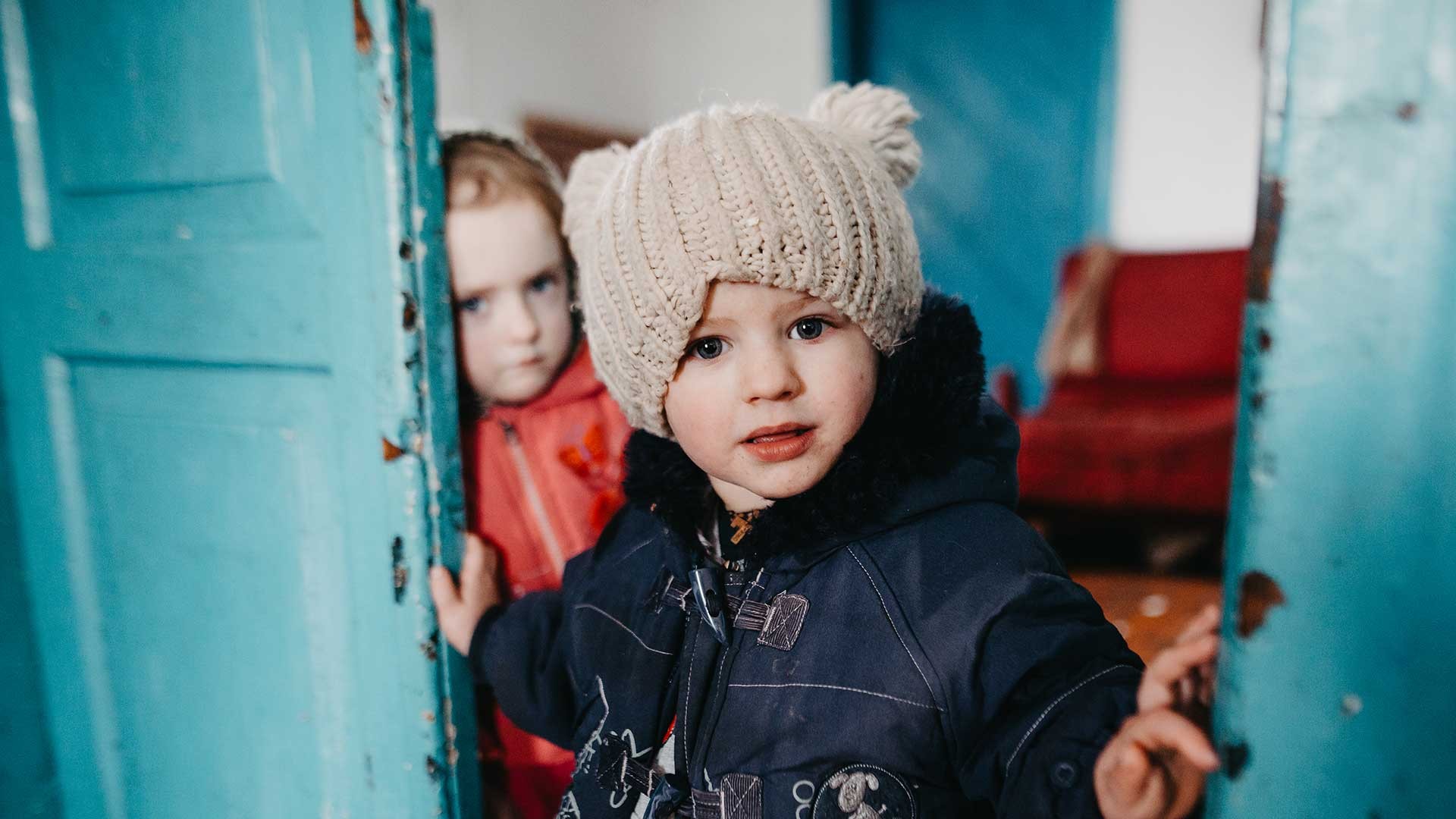 A child wrapped up warm in their home.