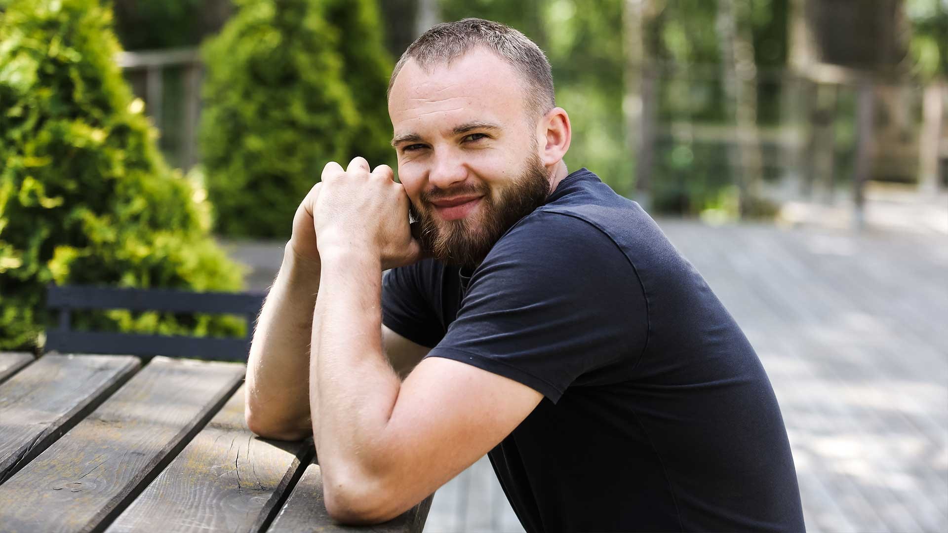 A young man sits outside.