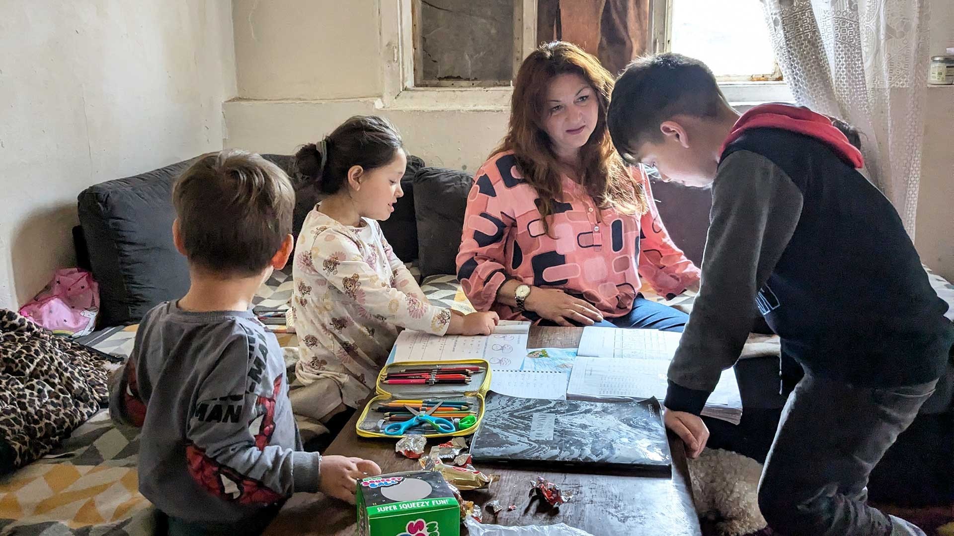 A Mission coordinator helps children with their school work.